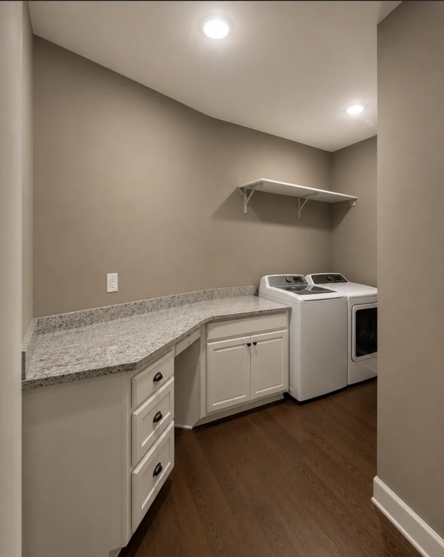 Laundry room after painting - clean walls, granite countertop, updated hardware